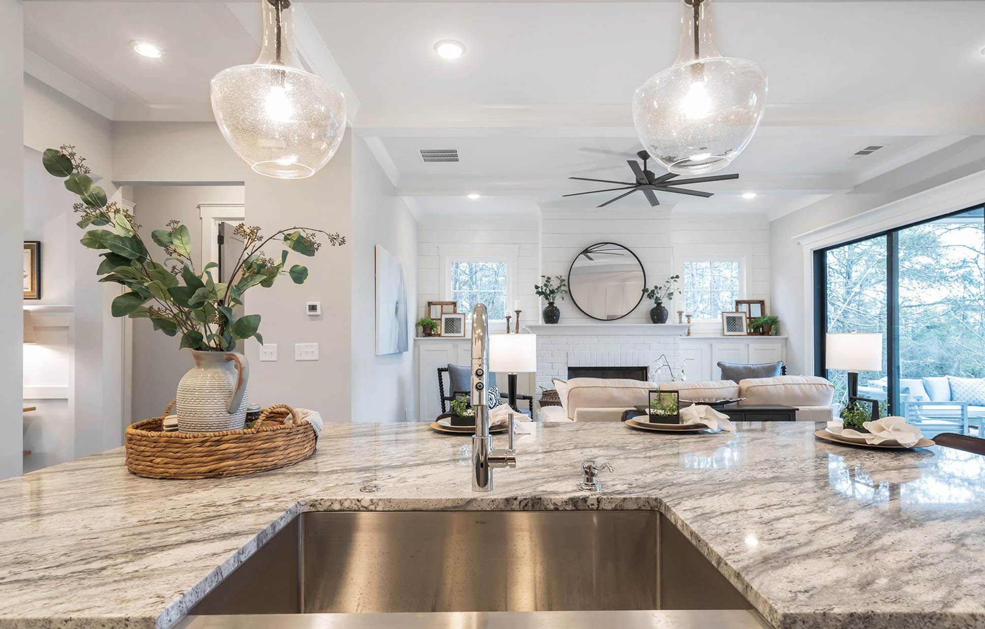 A kitchen with quartz counter tops and stainless steel appliances.